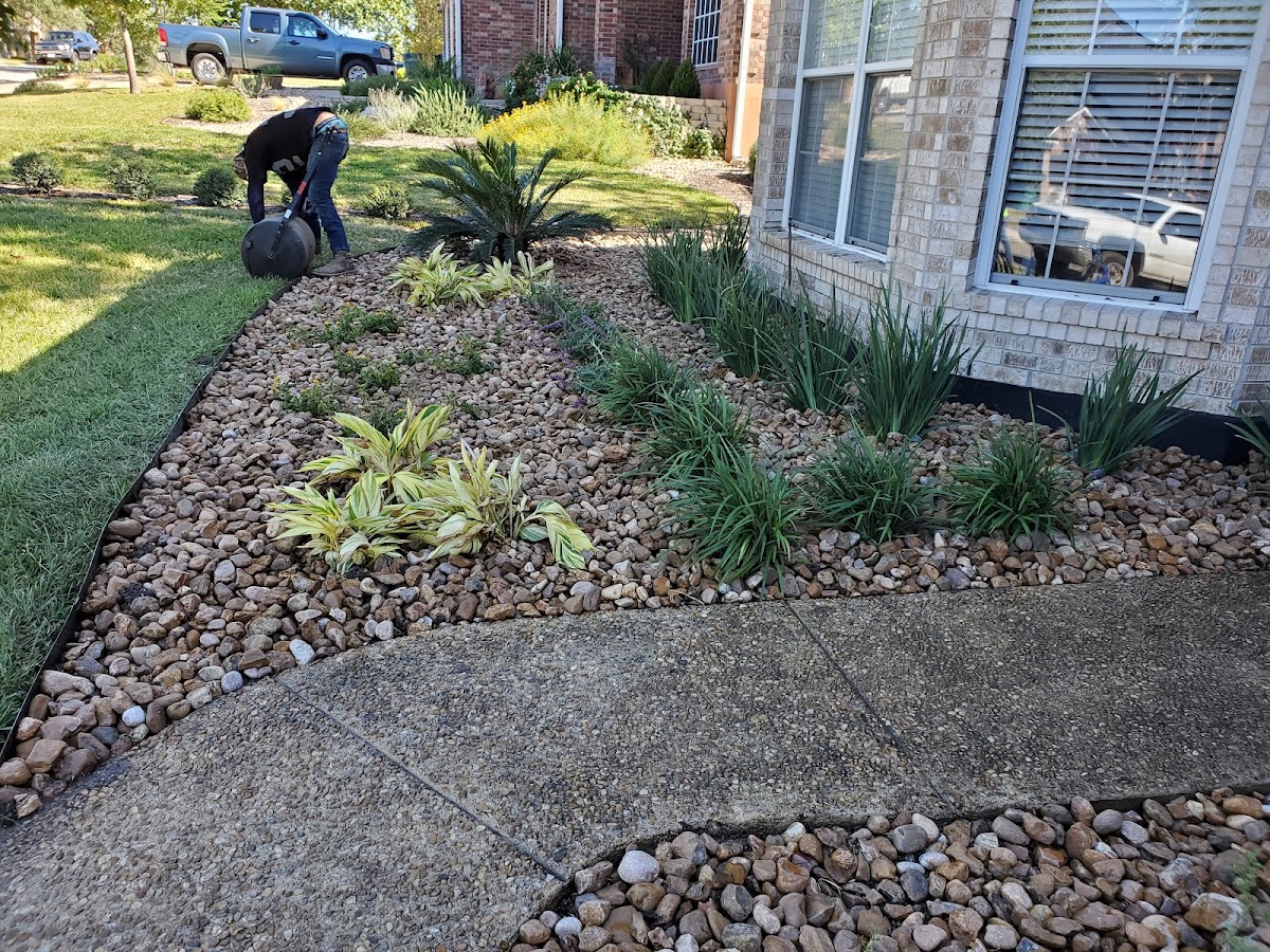 Jason's team at work installing a decorative landscape bed in Seguin TX